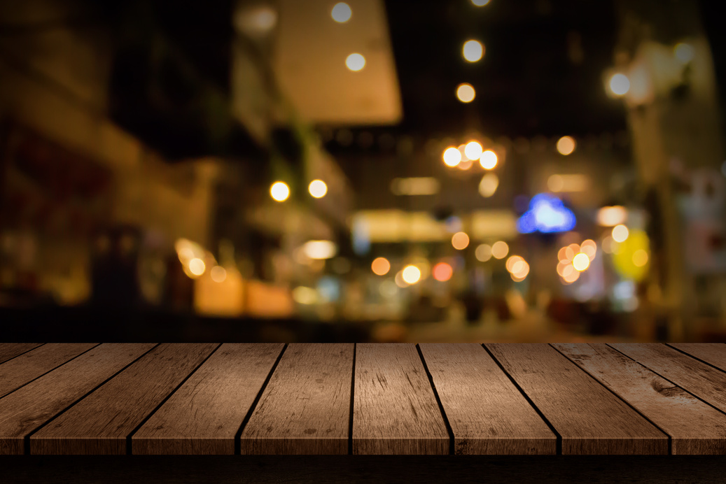 Wooden Table in Restaurant with Bokeh Light Background